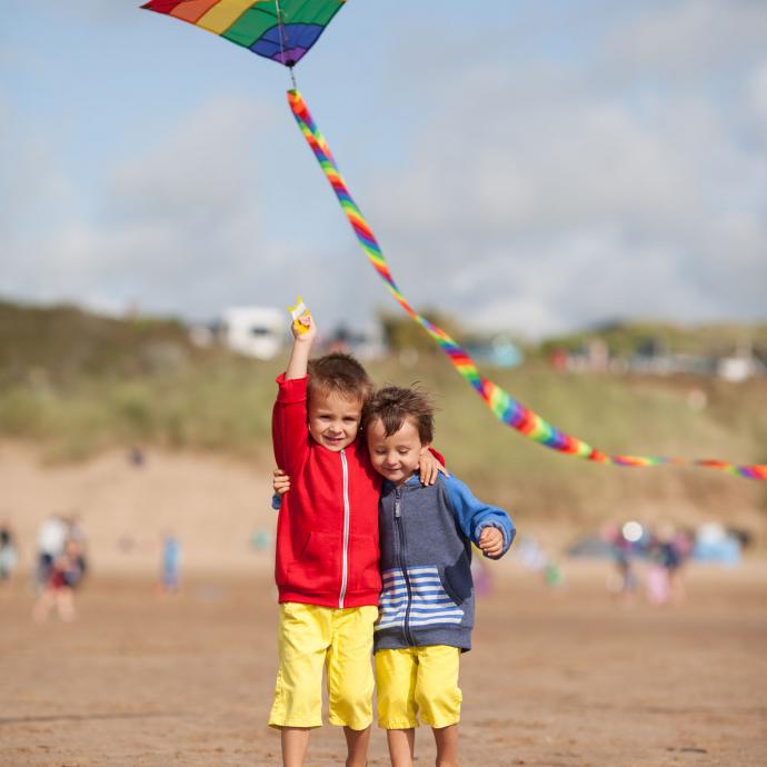 Kids flying a kite on Woolacombe Beach North Devon