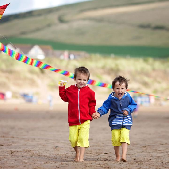 Kids flying a kite on Woolacombe Beach North Devon